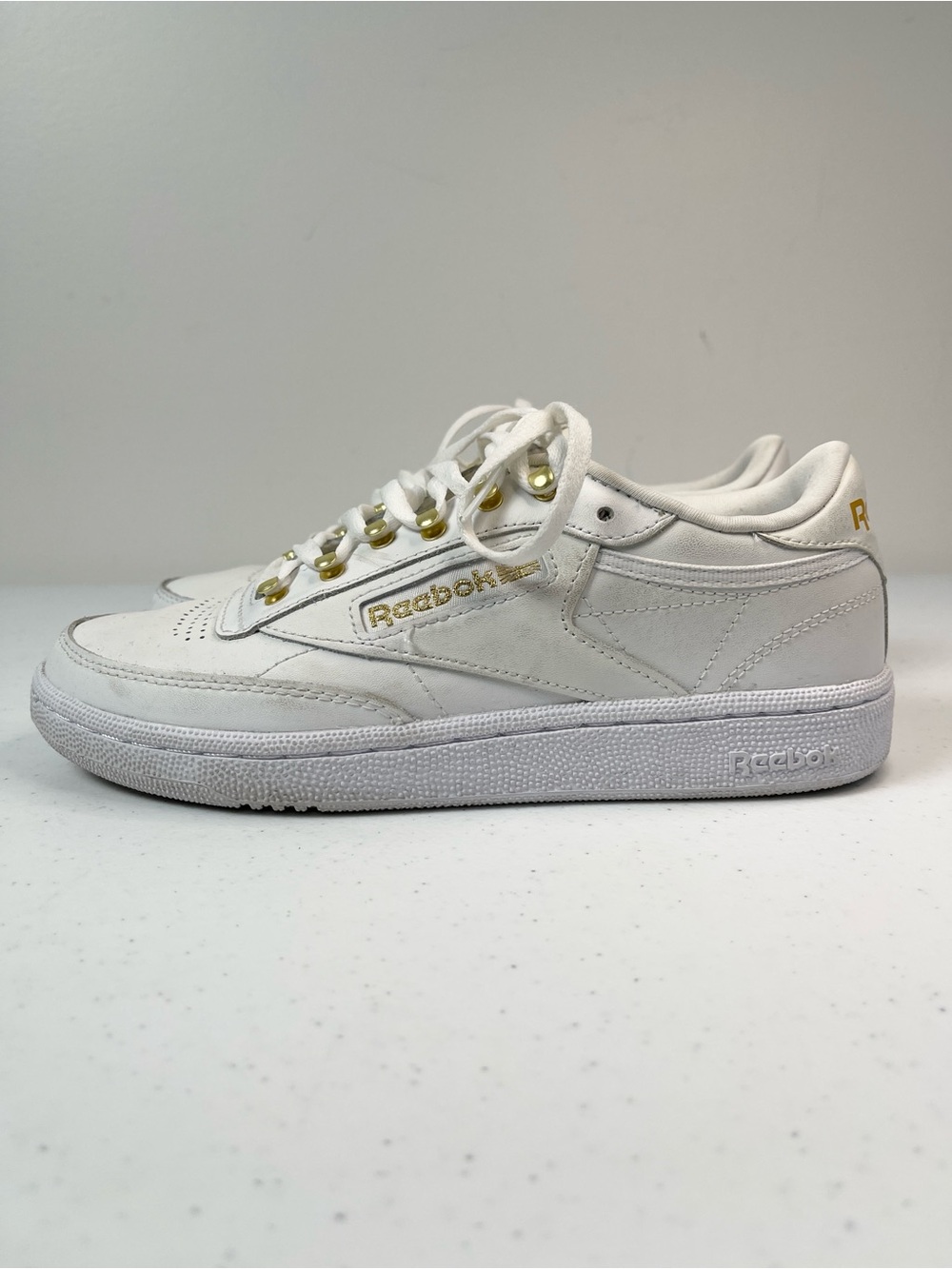 Reebok White Leather Low-Top Sneakers with Gold Accents